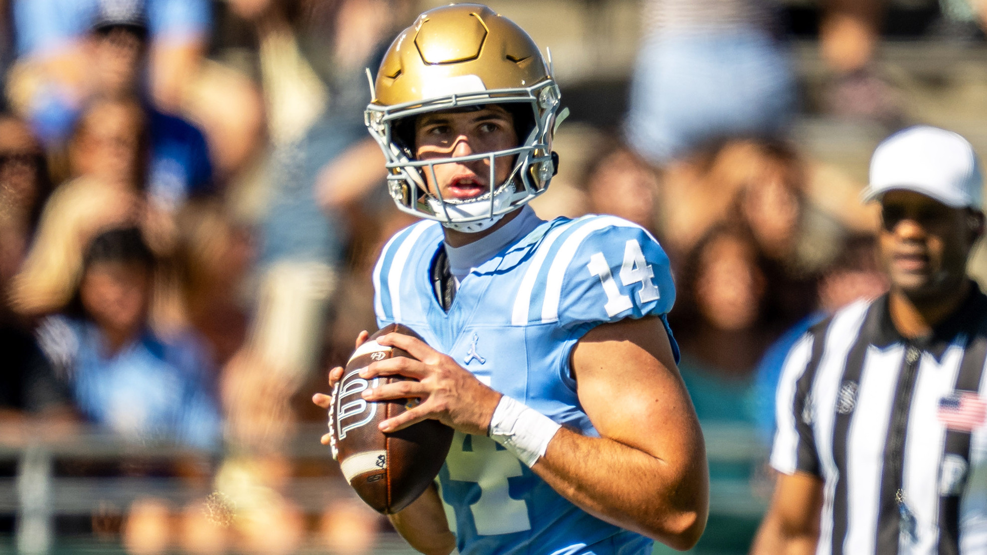 Ty Dieffenbach drops back to throw a pass against Michigan State