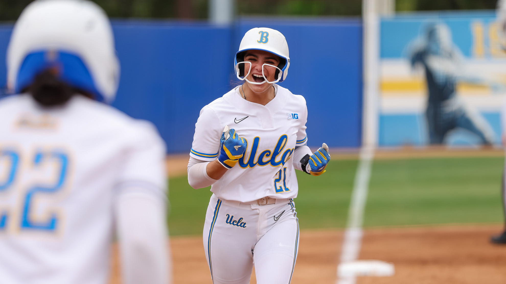 Aleena Garcia pumps her fists rounding third base after a home run