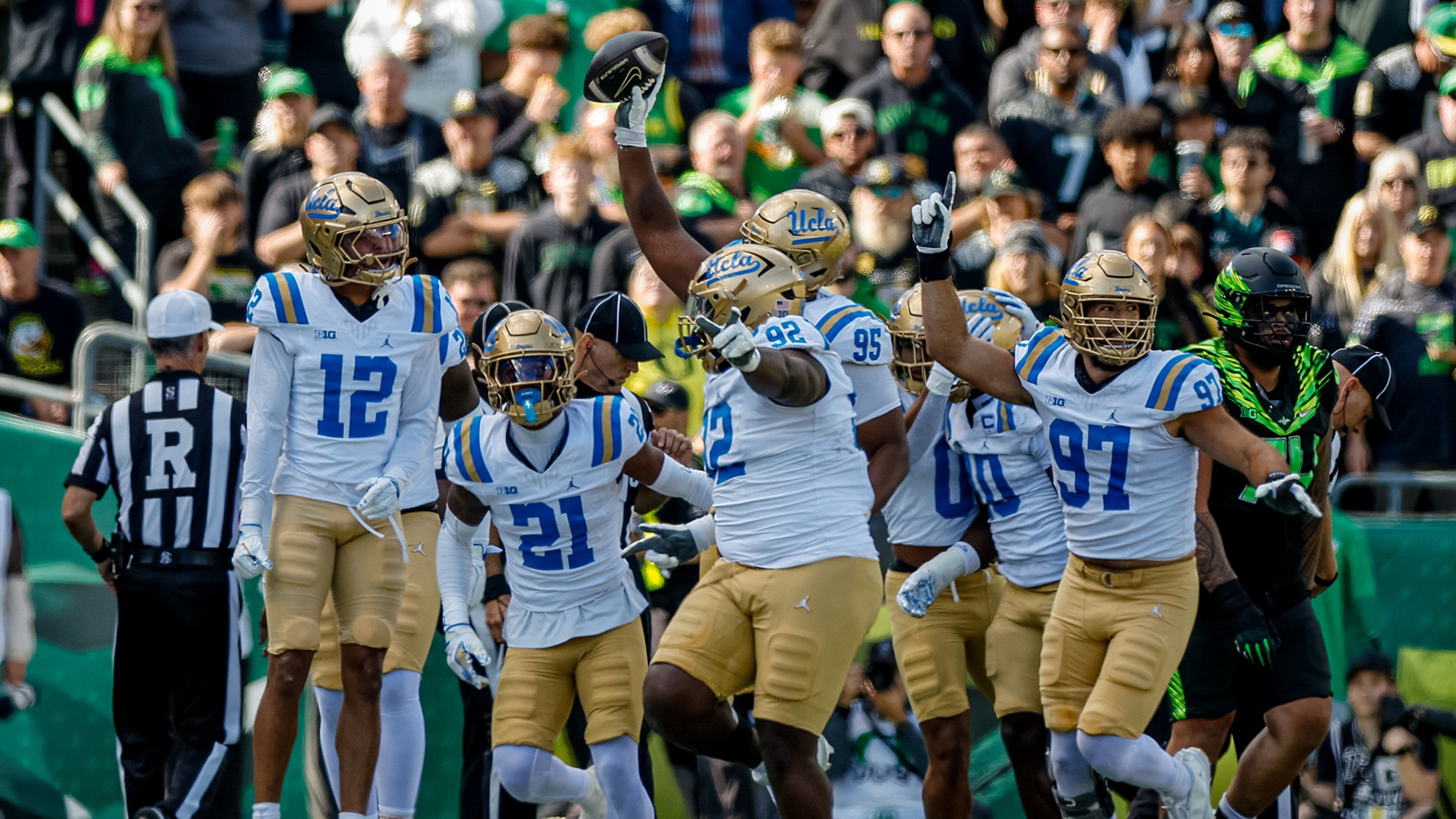 UCLA's defense celebrates after a fumble recovery