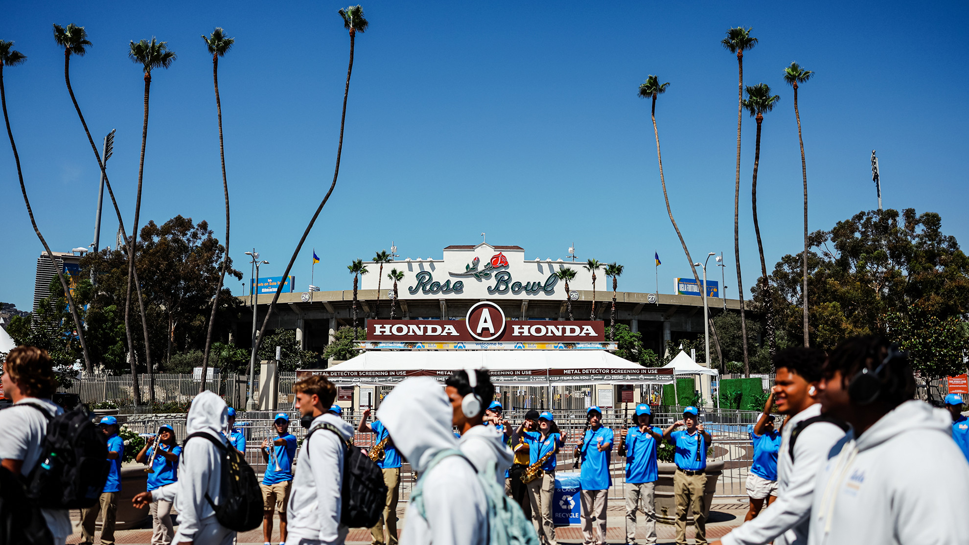 UCLA Football Student-Athletes walk by the Rose Bowl façade during Bruin Walk