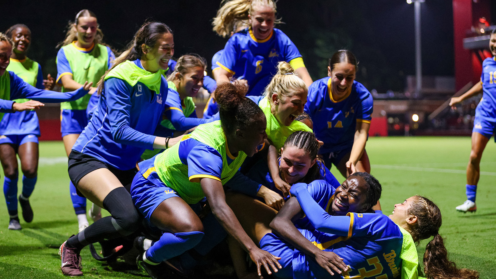 UCLA dogpiles Kara Croone after the go-ahead goal at USC
